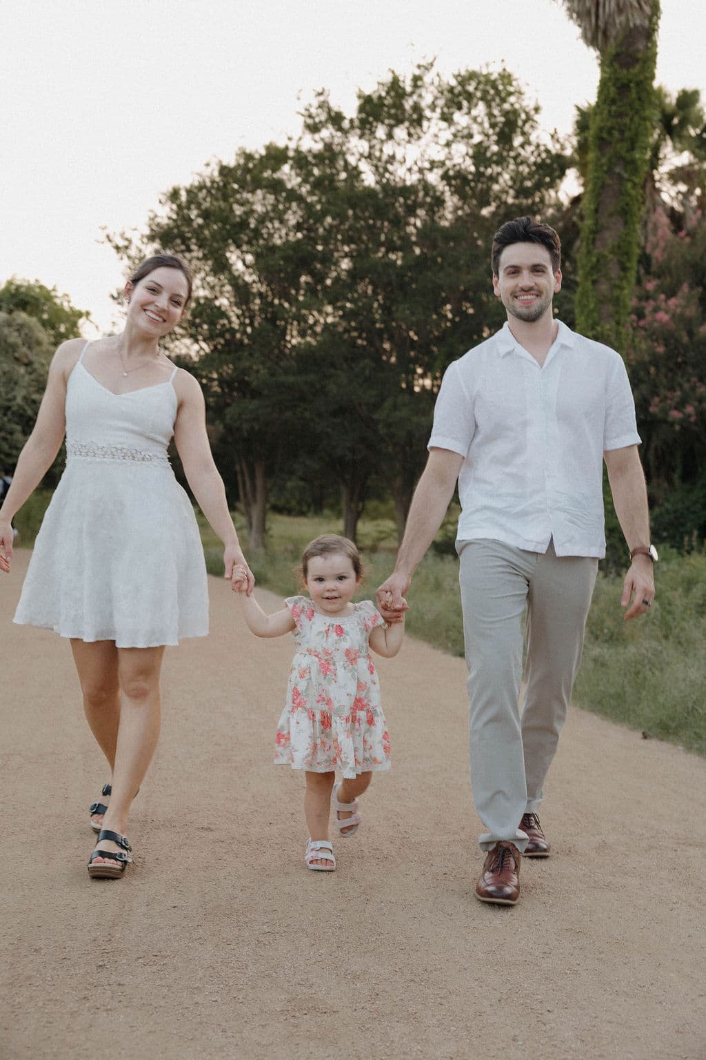 Caleb Dupae walking with his wife and daughter